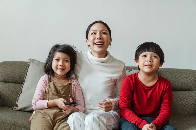 A family watching television together in a living room