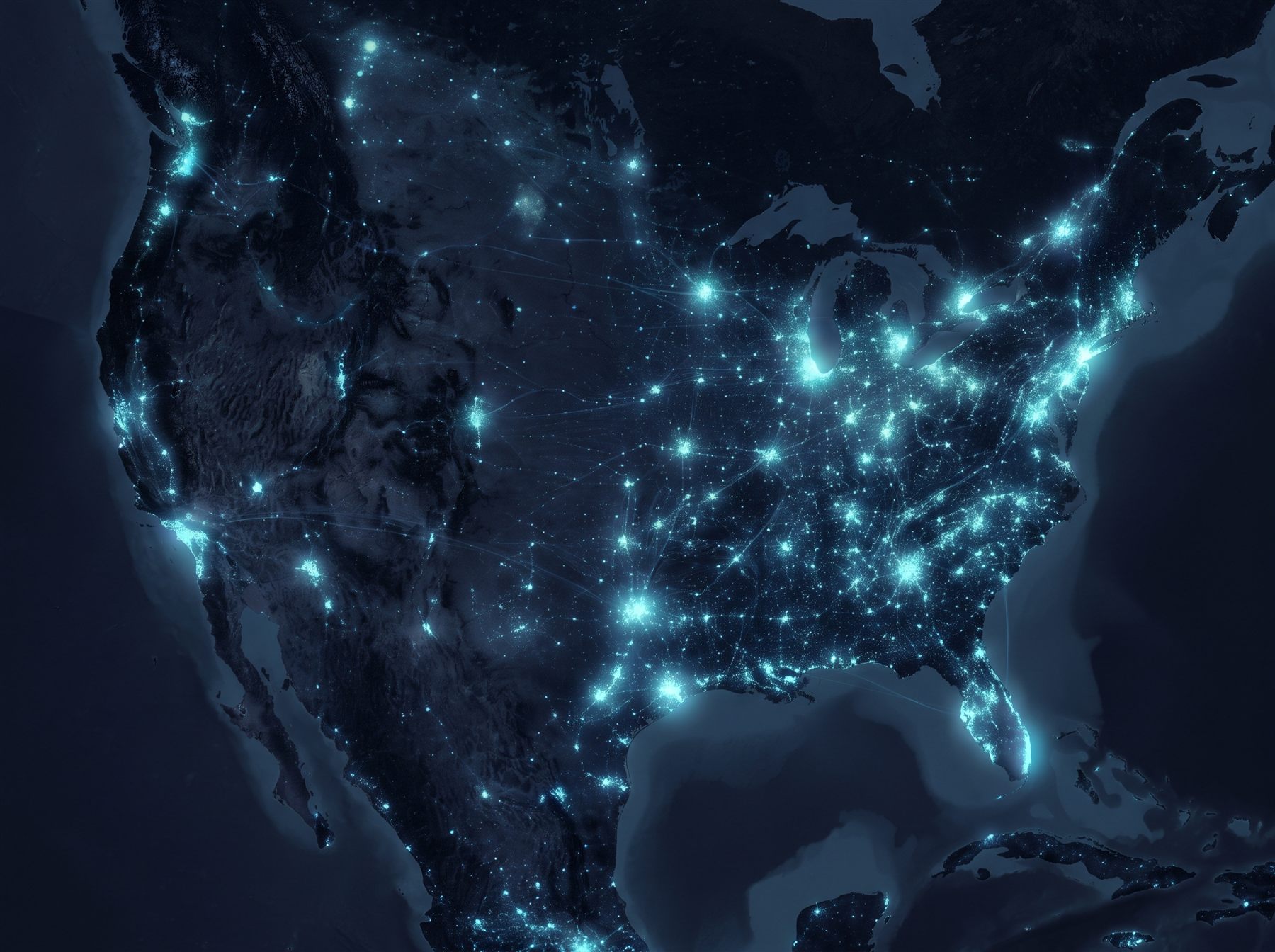 The United States at night seen from above, with cities glowing blue