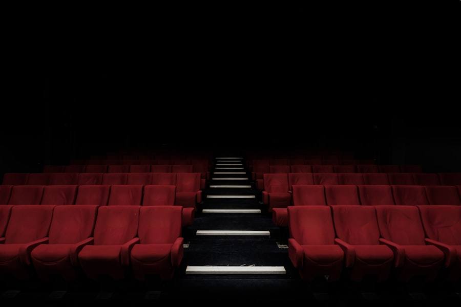 Rows of empty red seats in a darkened movie theater