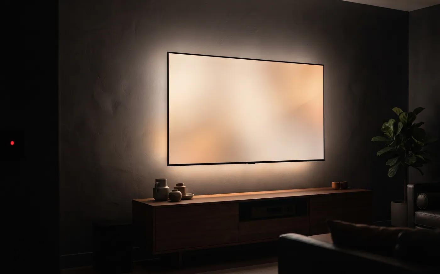 A backlit wall-mounted TV above a low wooden console in a dim living room