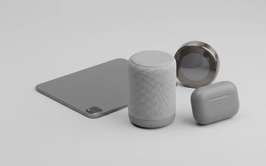 A tablet, a fabric-covered smart speaker, a round thermostat and an earbuds case